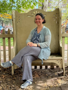 Sarah Johnson seated in an oversized wooden chair